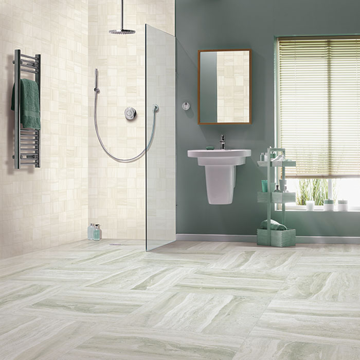 sage green bathroom with large-scale marble-look floor tile and small square wall tile